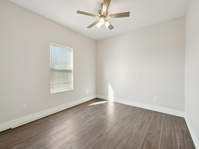 empty room with ceiling fan and dark hardwood / wood-style floors