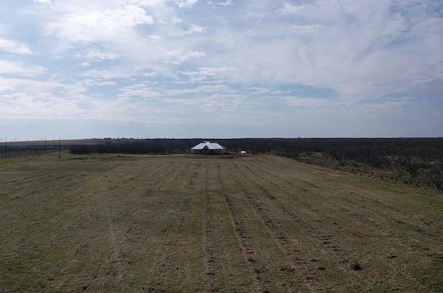 view of yard with a rural view