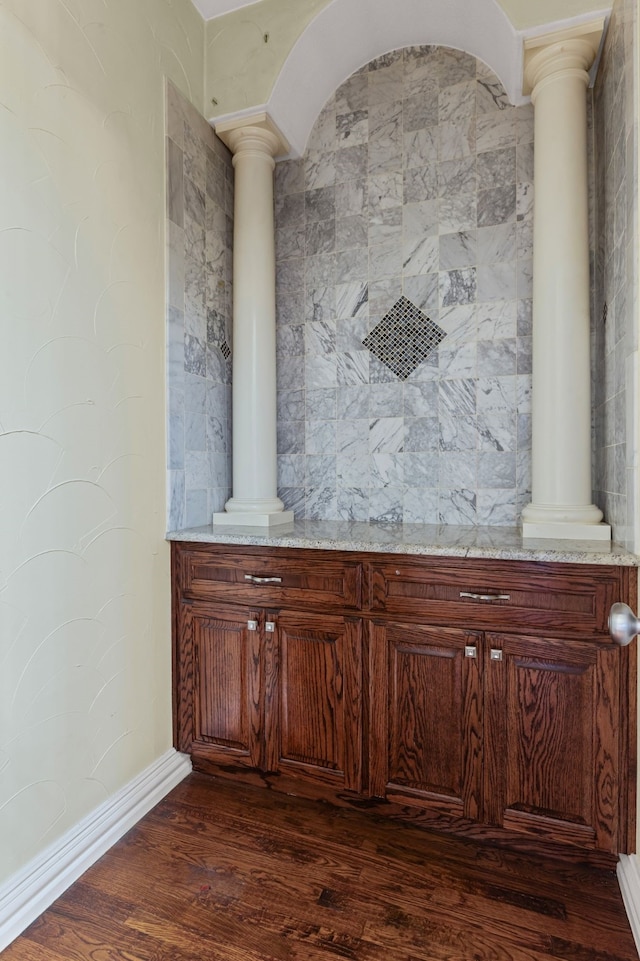 details featuring hardwood / wood-style flooring and ornate columns