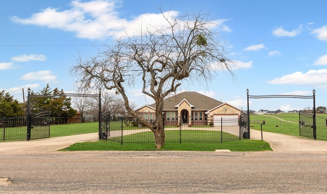 view of front of house featuring a garage and a front lawn