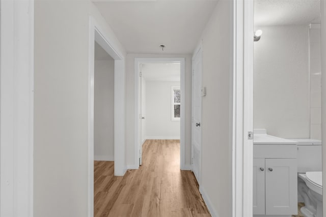 hallway with light hardwood / wood-style flooring