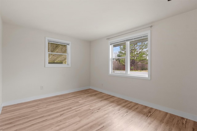 spare room with light hardwood / wood-style floors