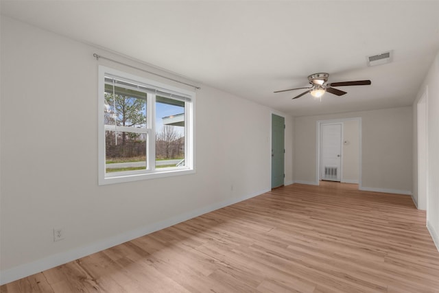 spare room with ceiling fan, radiator, and light hardwood / wood-style floors