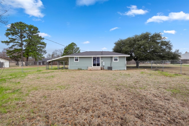 rear view of house with a yard and a carport