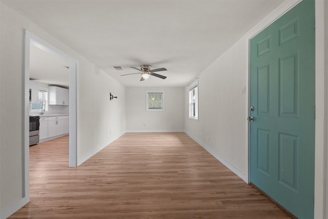 empty room featuring ceiling fan and light hardwood / wood-style floors