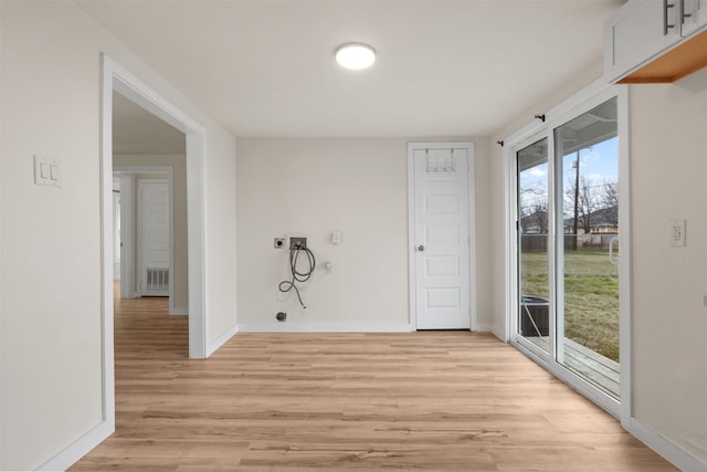 spare room featuring light hardwood / wood-style floors