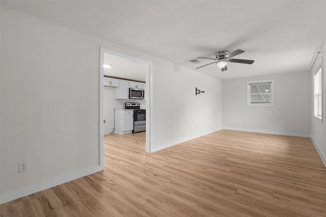 spare room featuring light hardwood / wood-style floors and ceiling fan