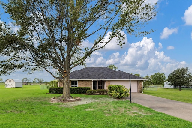 ranch-style house with a storage shed, a garage, and a front lawn