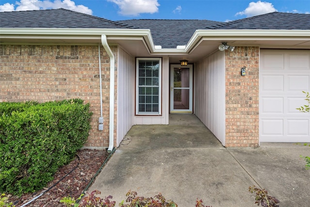 view of exterior entry with a garage