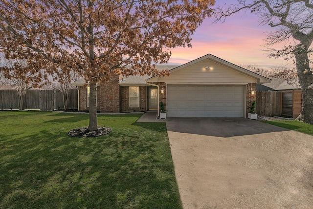 ranch-style house with a garage and a yard