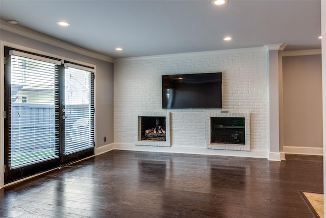 unfurnished living room with dark wood-type flooring, ornamental molding, and a fireplace