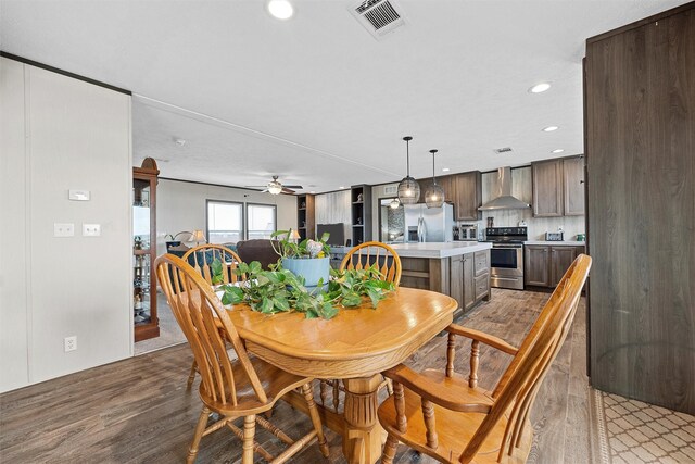 dining area featuring hardwood / wood-style floors and ceiling fan