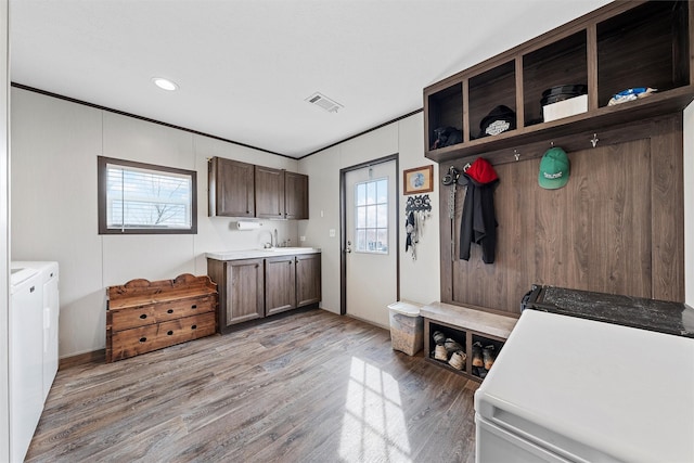 mudroom featuring separate washer and dryer, sink, a wealth of natural light, and light hardwood / wood-style floors