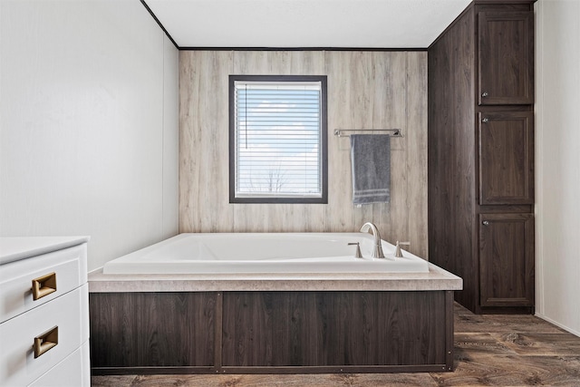 bathroom with vanity, a bath, and hardwood / wood-style floors