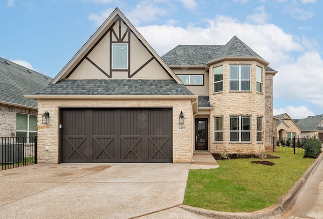 2415 Vineyard Dr, Granbury, TX 76048 - view of front of property featuring driveway, fence, a front lawn, and stone siding