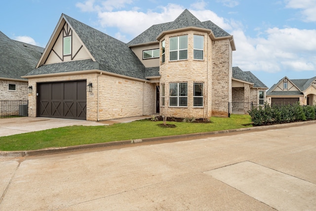 view of front of property featuring a garage and a front lawn