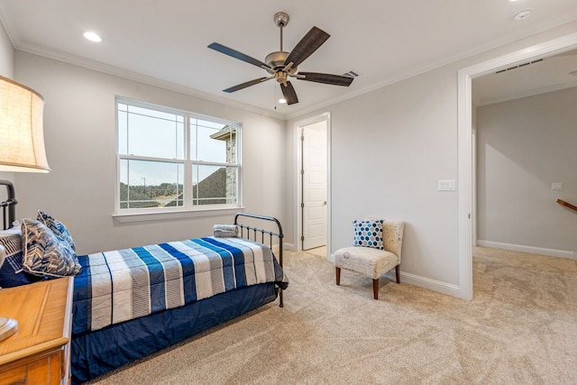 carpeted bedroom with ornamental molding and ceiling fan