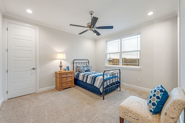 bedroom with ceiling fan, ornamental molding, and light carpet