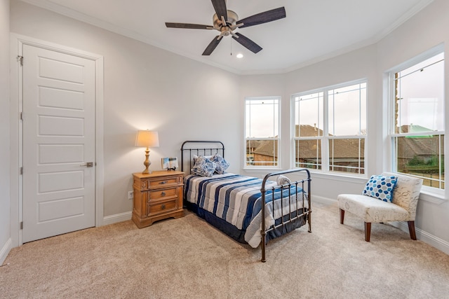 bedroom featuring ceiling fan, light colored carpet, and ornamental molding