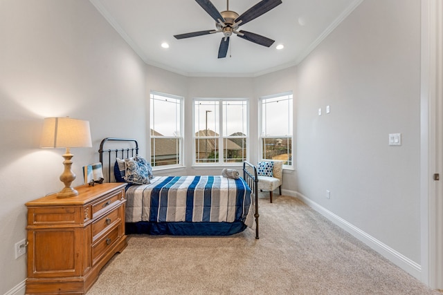 bedroom featuring crown molding, light colored carpet, and ceiling fan