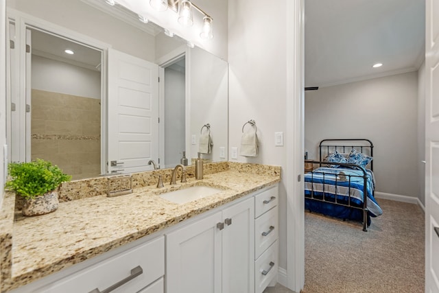 bathroom featuring crown molding and vanity