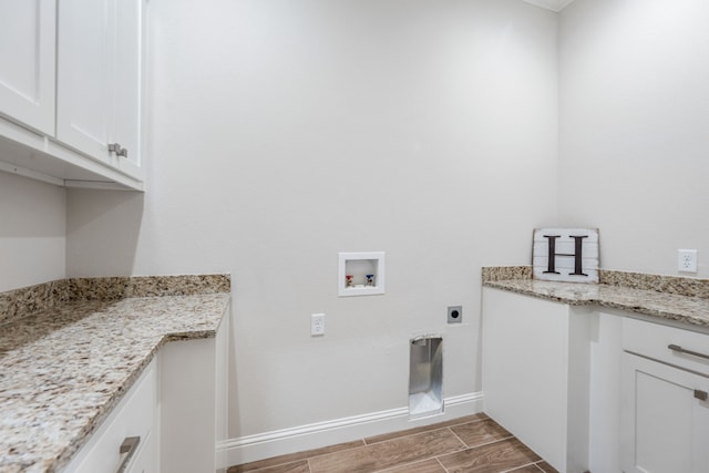 laundry area featuring cabinets, hookup for a washing machine, and electric dryer hookup