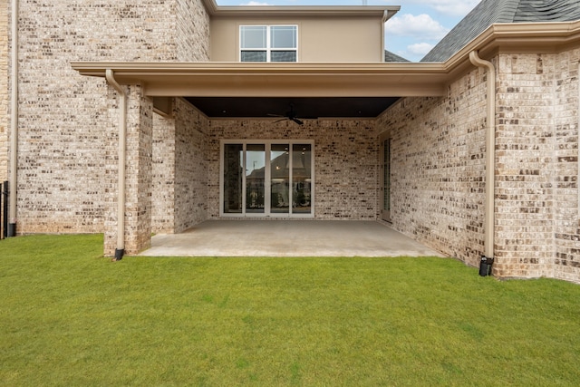 back of house featuring a patio, a yard, and ceiling fan