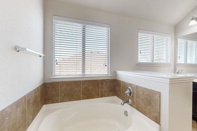 bathroom with a tub to relax in and vanity