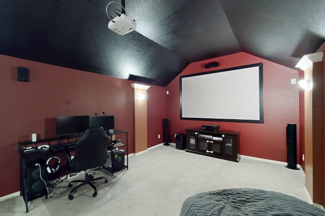 carpeted home theater with vaulted ceiling and a textured ceiling