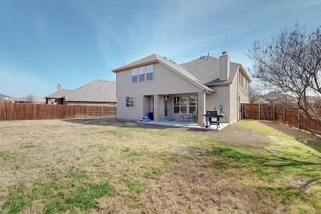 rear view of property with a patio and a lawn