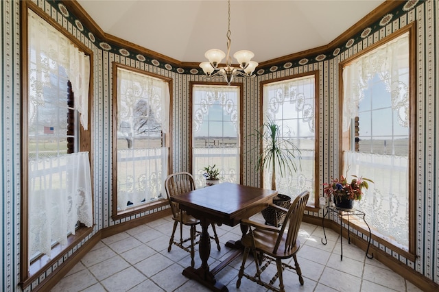 dining area with a notable chandelier, light tile patterned flooring, vaulted ceiling, and crown molding