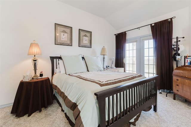 carpeted bedroom featuring lofted ceiling