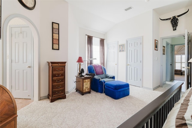 sitting room featuring plenty of natural light, vaulted ceiling, and light colored carpet