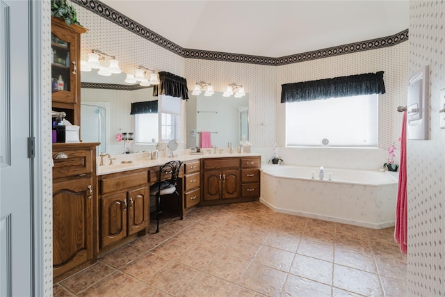 bathroom with tile patterned floors, vanity, and a bath