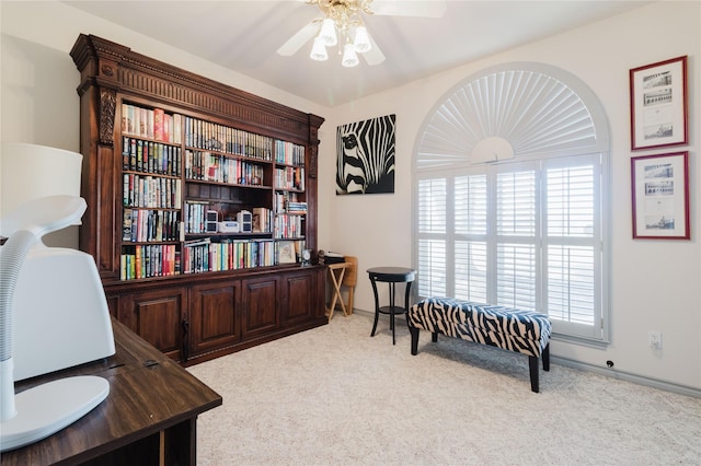 carpeted office space with ceiling fan