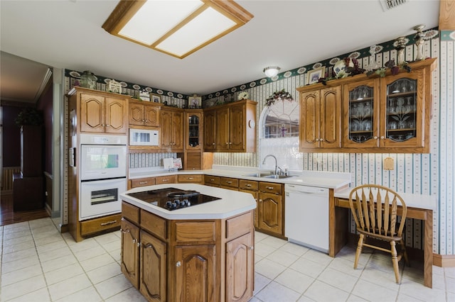 kitchen with sink, white appliances, a kitchen island, and light tile patterned flooring