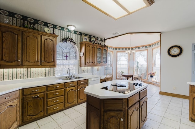 kitchen featuring lofted ceiling, a center island, a notable chandelier, sink, and light tile patterned flooring