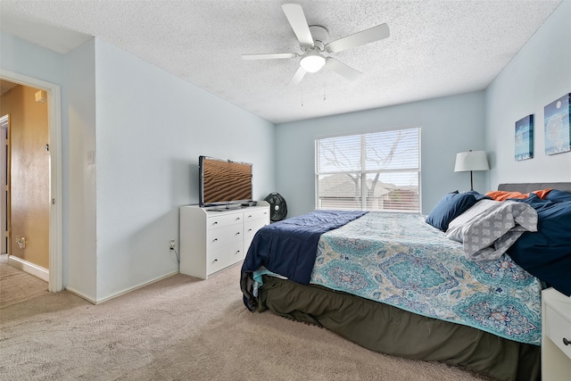 728 Oriole Dr, Saginaw, TX 76131 - bedroom featuring a textured ceiling, ceiling fan, baseboards, and light colored carpet