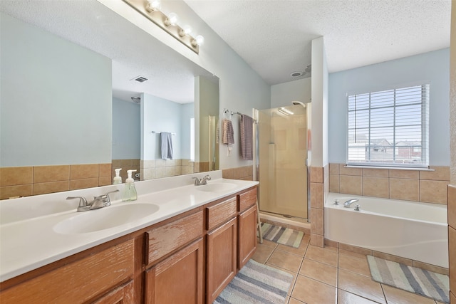 728 Oriole Dr, Saginaw, TX 76131 - full bath with a garden tub, a sink, a textured ceiling, and tile patterned floors