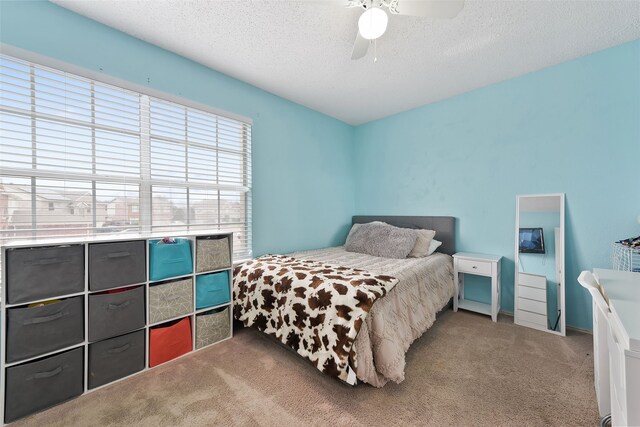 728 Oriole Dr, Saginaw, TX 76131 - carpeted bedroom with ceiling fan and a textured ceiling