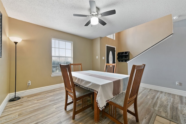 728 Oriole Dr, Saginaw, TX 76131 - dining room with baseboards, a textured ceiling, and light wood-style floors