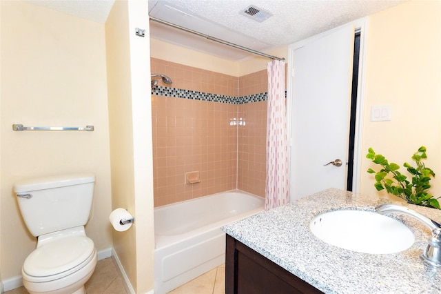 full bathroom with tile patterned flooring, vanity, toilet, a textured ceiling, and shower / bath combo with shower curtain