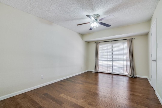 spare room with a textured ceiling, dark wood-type flooring, and ceiling fan