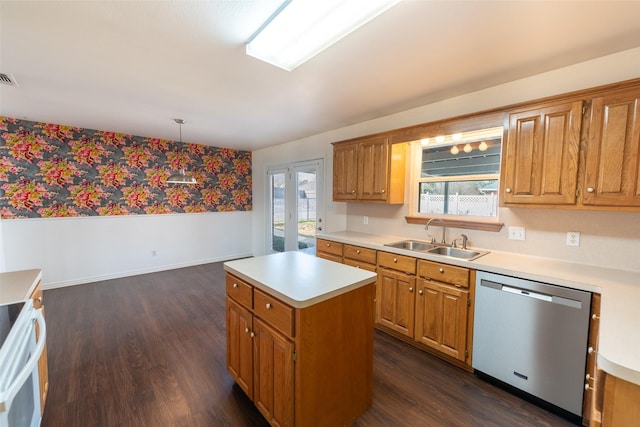 kitchen with decorative light fixtures, dishwasher, sink, dark hardwood / wood-style flooring, and a center island