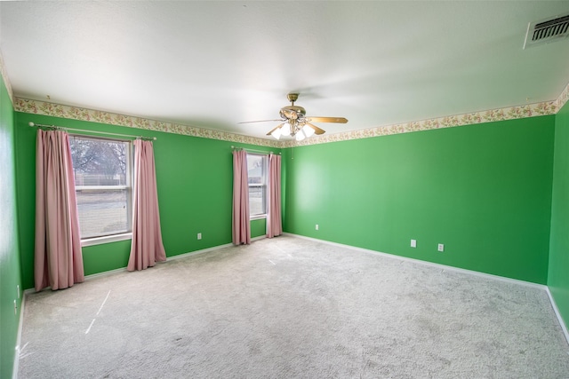 empty room featuring ceiling fan and carpet flooring