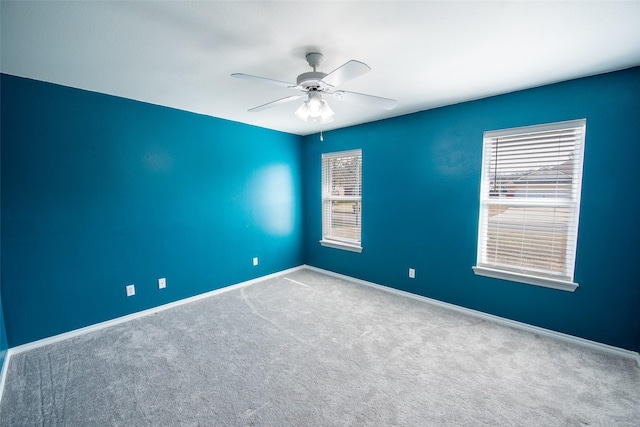 carpeted empty room with ceiling fan