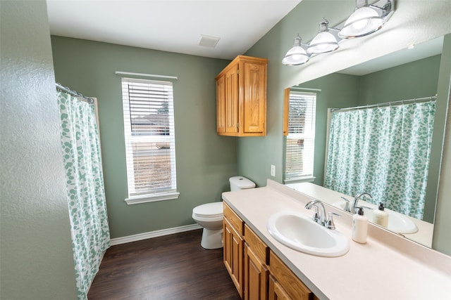 bathroom featuring wood-type flooring, toilet, curtained shower, and vanity