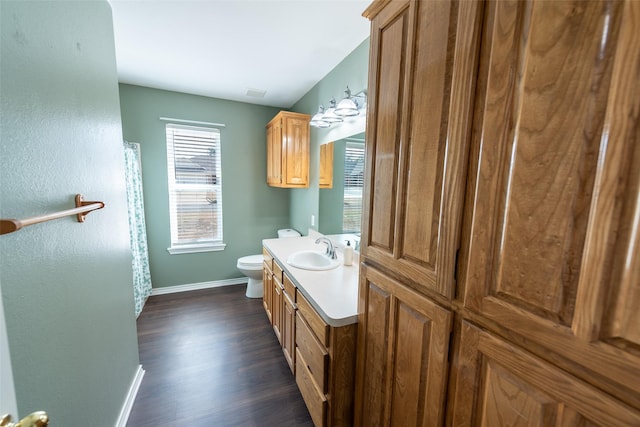 bathroom with vanity, toilet, and hardwood / wood-style floors