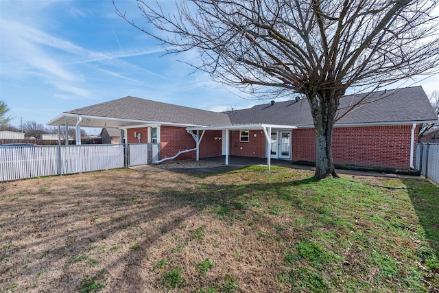 rear view of house with a lawn