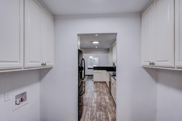 clothes washing area with hardwood / wood-style floors and hookup for a washing machine